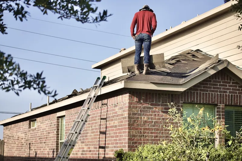 Professional roofer working on a residential roof in Railyard